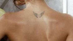 a woman with a butterfly tattoo on her back