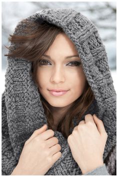 a woman wearing a gray scarf and hood