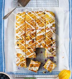 a pan filled with sliced up desserts on top of a blue and white towel