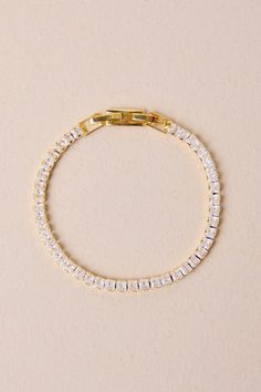 With a little something like the Lulus Perfectly Upscale Gold Rhinestone Tennis Bracelet on your wrist, everyone will know you're a luxe lady! Shiny, gold-toned metal shapes this stunning bracelet that has a slender design, with sparkling inset rhinestones that create a tennis bracelet-style silhouette. Clasp closures. Bracelet measures 5. 5" long. Man Made Materials. Imported. Lulus | Perfectly Upscale Gold Rhinestone Tennis Bracelet. Gold Crystal Bracelet Jewelry, Gold Rhinestone Metal Bracelets, Gold Rhinestone Bracelets, Adjustable Gold Chain Bracelet With Rhinestones, Elegant Gold Crystal Bracelet With Sparkling Stones, Gold Metal Bracelets With Rhinestones, Elegant Gold-tone Rhinestone Jewelry, Gold Crystal Bracelets With Jewels, Gold Plated Bracelets With Sparkling Stones