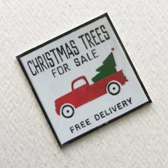 a red truck with a christmas tree for sale on it's back is shown