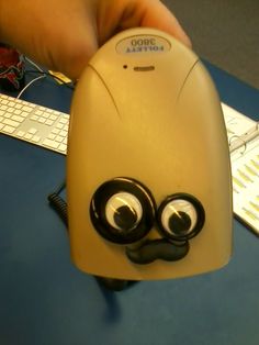 a close up of a computer mouse with eyes