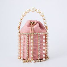 SPECIFICATIONSStyle: FashionShape: BucketPlace Of Origin: GUANG DONG ProvincePattern Type: Hollow OutOrigin: CN(Origin)Occasion: PartyModel Number: AK-1912202Main Material: MetallicLining Material: PolyesterInterior: Cell Phone PocketHardness: HARDGender: WOMENDecoration: DiamondsDecoration: BeadingDecoration: Hollow OutDecoration: ChainsDecoration: PearlClosure Type: STRINGBrand Name: AlizekerrMaterial: Metal Craft :Handmade Size:  Length 5.31in/13.5cm  Width 5.31in/13.5cm  Height 4.72in/12cm N Ladies School Bag, Metallic Clutch Bag, Pearl Clutch Bag, Chic Purses, Metallic Handbags, Pearl Clutch, Wedding Handbag, Bridal Handbags, Designer Clutch Bags