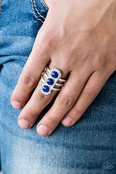 Infused with glassy blue beads, a studded silver frame is pressed into the center of a layered silver band for a seasonal look. Features a stretchy band for a flexible fit. Sold as one individual ring. P4SE-BLXX-153XX Emerald Style, Trio Ring, Blue Ring, Paparazzi Accessories, Blue Gems, Affordable Jewelry, Paparazzi Jewelry, Blue Rings, Silver Cuff