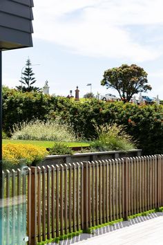 a wooden fence next to a lush green field