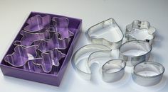 there are many cookie cutters in the box and one is empty on the table