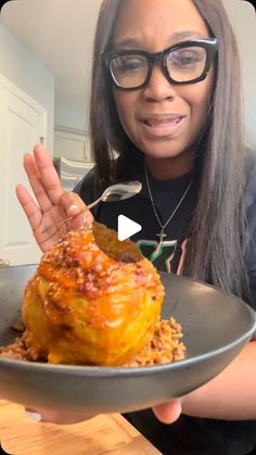 a woman holding a plate with food on it