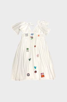 Chopova Lowena’s pristine white Cradler midi dress is made from cotton and adorned with multiple badges, underpinning the label’s grunge influences and Bulgarian folklore motifs. Fit runs true to size 100% Organic Cotton This item is Final Sale. Bulgarian Folklore, Folklore Dress, Chopova Lowena, The Label, Video Game, Final Sale, Iphone Wallpaper, White Dress, Organic Cotton