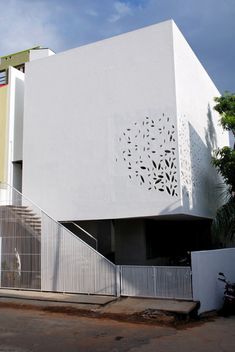 a large white building with an intricate design on it's side and stairs leading up to the entrance