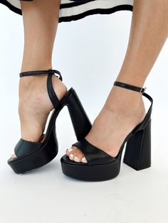 Elevate your style with our Black Open Toe Platform Heel. This elegant heel features a platform and block heel for elevated comfort, perfect for formal occasions like dinner, drinks, or date night. The open toe and strappy details add a touch of sophistication, making it a must-have for any fashion-forward individual. Heel height: 5"