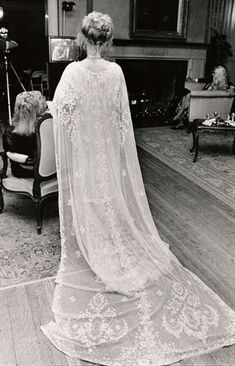 the back of a woman's wedding dress in an old photo