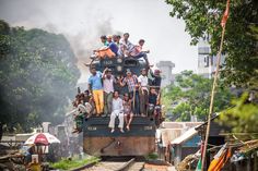 a group of people riding on the back of a train