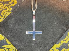 Dark times call for Darkness Jewelry. This custom-made Inverted Upside Down Cross Satanic Pendant Necklace is both timeless and retro. Perfect for minimalist Pagan Satanic symbolism. Pendant is designed for everyone and is stunning in its silver color and is a sight to behold! Chain is also stainless steel and silver in color. Show your support of The One behind all of this madness and be saved when He sets foot upon the land. Material: Stainless Steel, Steel Color: Silver Dimensions: Necklace l Minimalist Stainless Steel Cross Necklace With Adjustable Chain, Minimalist Stainless Steel Cross Necklace As A Gift, Minimalist Silver Stainless Steel Cross Necklace, Minimalist Stainless Steel Cross Necklace For Gift, Modern Stainless Steel Cross Necklace For Gift, Symbolic Stainless Steel Cross Jewelry, Symbolic Stainless Steel Cross Necklace, Minimalist Stainless Steel Cross Pendant Jewelry, Nickel-free Stainless Steel Cross Pendant Necklace