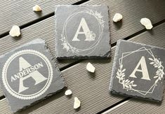 three slate coasters with the letters a, b and c in white on them