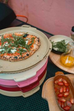 a pizza sitting on top of a stack of plates