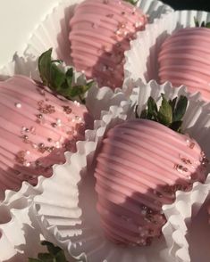 pink chocolate covered strawberries in white paper wrappers