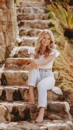 a woman is sitting on some steps outside