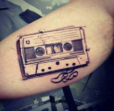 a tattoo with an old school cassette tape on it