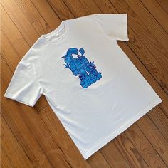 a white t - shirt with a blue crab on it