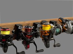 several different types of fishing reels are lined up