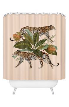 a shower curtain with two cheetah and leaves on the bottom, in front of a beige background