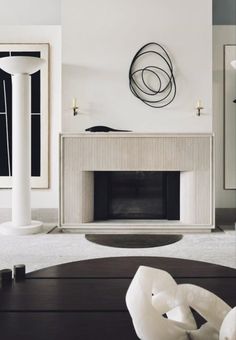 a living room with a fireplace and white walls