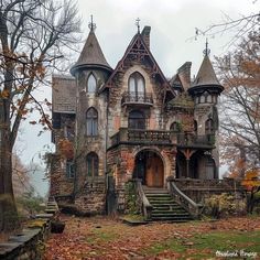 an old house in the fall with leaves on the ground and stairs leading up to it