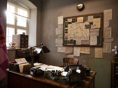 an old desk with many papers on it