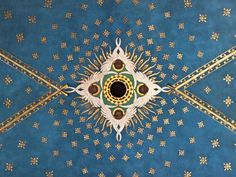 the ceiling is painted with gold and blue colors, including an intricate design on it