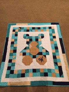 a blue and brown quilt with the word no on it's centerpieces