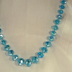 Iridescent Aquamarine Doublet Cut Crystals Beads Necklace Large Center Bead Size 15mm Across Wide Chain Length 30.5" To 33"Neckline. New Never Worn. Blue Faceted Round Bead Necklaces, Blue Faceted Round Bead Crystal Necklace, Adjustable Faceted Blue Crystal Necklace, Blue Faceted Crystal Necklace With Round Beads, Blue Faceted Necklaces With Round Beads, Blue Necklaces With Faceted Round Beads, Light Blue Round Bead Necklaces For Party, Light Blue Beaded Necklaces For Party, Blue Faceted Beads Crystal Necklaces