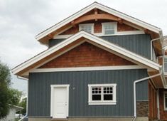 a gray and brown house with white trim