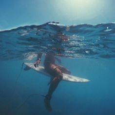 a man riding a surfboard under water