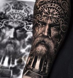 a man's arm with tattoos and an image of a bearded man on it