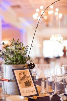 the centerpieces are decorated with flowers in buckets