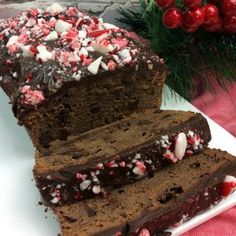 two slices of chocolate peppermint cake on a plate with flowers in the background