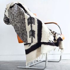 a black and white blanket sitting on top of a chair