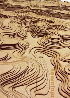 an intricate wood carving pattern on the side of a wooden board that has wavy lines in it