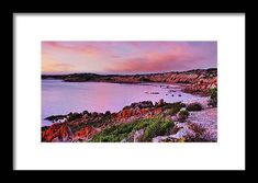 an image of the ocean at sunset with rocks and water in the foregrounds