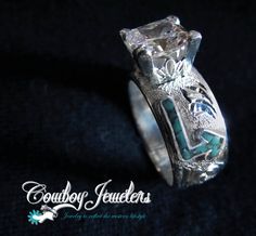 a close up of a ring on a black background with the words gourley jewelers