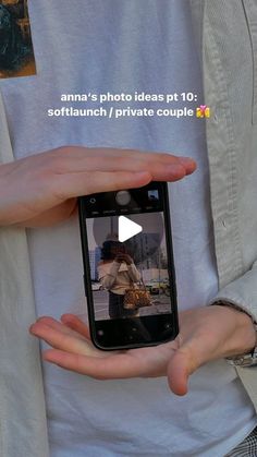 a person holding a cell phone in their hands with the video on it's screen