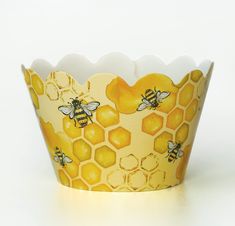 a paper cup that has some bees on it