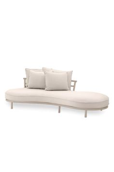 a white couch with three pillows on it