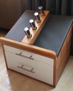 a wooden table with drawers and knobs on it