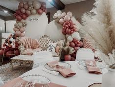 a table set up for a party with balloons and decorations