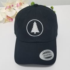 This hat is made in the USA, so wear it proud! It's unstructured with a curved visor and adjustable strap, and an American flag sewn on the back. PINE TREE Hat / Wildlife Cap / Hiking Baseball Cap / Adventure Custom Embroidery / Best Friend Gift / Camping Embroidered Hat / Forest Woods * 100% washed cotton chino twill * Unstructured, 6-panel, low-profile * Adjustable strap with hide-away buckle - US FREE SHIPPING! - High Quality - Closure: Self-fabric adjustable strap slide closure with buckle. Curved Bill Fitted Hat With Embroidered Logo, Embroidered Adjustable Trucker Hat For Outdoor, Outdoor Embroidered Trucker Baseball Cap, Embroidered Trucker Hat For Outdoor, Embroidered Outdoor Baseball Cap, Cotton Hat With Curved Visor For Outdoor, Cotton Curved Visor Hat For Outdoor, Snapback Cap With Embroidered Logo For Outdoor Activities, Custom Embroidered Adjustable Flat Bill Baseball Cap