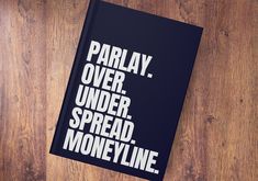 a book that is sitting on top of a wooden table with the words parlay over under spread, money line