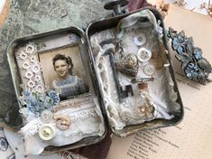 an open suitcase filled with lots of assorted items on top of a piece of paper