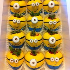 there are many yellow cupcakes with eyes on them