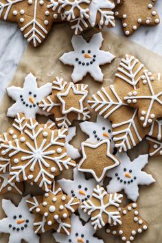 several decorated cookies sitting on top of a piece of parchment paper